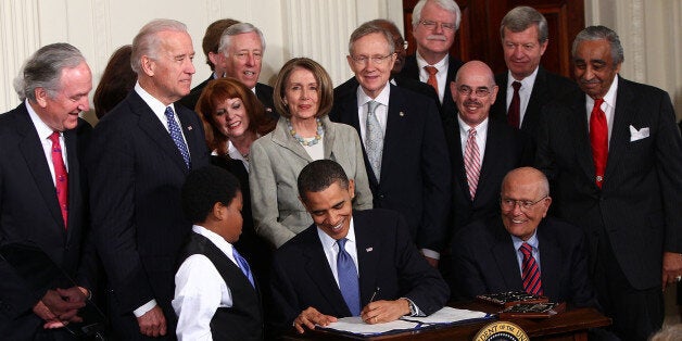 WASHINGTON - MARCH 23: U.S. President Barack Obama signs the Affordable Health Care for America Act during a ceremony with fellow Democrats in the East Room of the White House March 23, 2010 in Washington, DC. The historic bill was passed by the House of Representatives Sunday after a 14-month-long political battle that left the legislation without a single Republican vote. (Photo by Win McNamee/Getty Images)