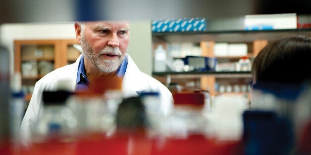 ROCKVILLE, MD - APRIL 12:J. Craig Venter talks with Li Ma, the scientist who made the initial transfers at the J. Craig Vente