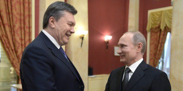 Russia's President Vladimir Putin (R) shakes hands with his Ukrainian counterpart Viktor Yanukovych before the official reception held on behalf of Russian President in honor of the distinguished guests of the XXII Olympic Winter Games.in Sochi, on February 7, 2014. Putin will welcome to the Sochi Olympic Games dozens of world leaders supportive of his rule but heads of state of big Western countries will be conspicuous by their absence. AFP PHOTO/ RIA-NOVOSTI/ POOL / ALEXEI NIKOLSKY (Photo credit should read ALEXEI NIKOLSKY/AFP/Getty Images)