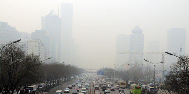 BEIJING, CHINA - DECEMBER 24 : The vehicles move hardly due to air pollution in Beijing, China,on December 24,2013. Air pollution was recorded at hazardous level in the centre of Beijing and the government announced that children, old people and those who are sensitive should not get out from their house. Chinese meteorology office recorded the pollution reached almoest its highest and hazardous level in capital states of the Xian, Hubei and 16 other cities (Photo by Ali Ihsan Cam/Anadolu Agency/Getty Images) 
