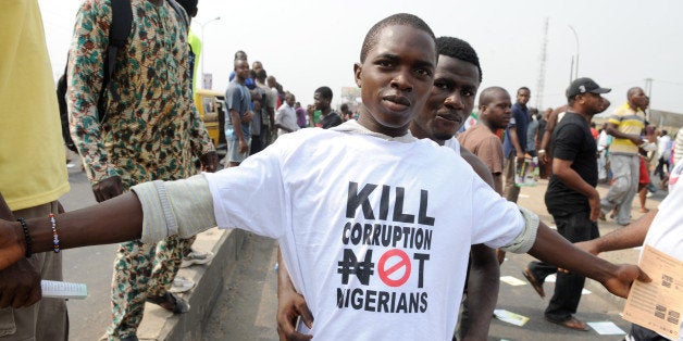 A protestor sports a an anti-corruption T-shirt on January 9, 2012 in Lagos during a demonstration against the more than doubling of petrol prices after government abolished fuel subsidies. Thousands of people heeded the unions' call to stage protest rallies across Africa's most populous country. Police shot dead a protester in Nigeria's commercial capital Lagos on January 9 during a national strike over fuel prices. AFP PHOTO / PIUS UTOMI EKPEI (Photo credit should read PIUS UTOMI EKPEI/AFP/Getty Images)