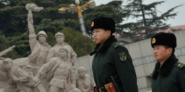 Chinese paramilitary stand guard in Tiananmen Square before the upcoming opening sessions of the Chinese People's Political Consultative Conference (CPPCC) and the National People's Congress (NPC) in Beijing on February 28, 2014. Thousands of delegates from across China and the Chinese leadership will gather for its annual legislature meetings next week in Beijing. AFP PHOTO/Mark RALSTON (Photo credit should read MARK RALSTON/AFP/Getty Images)