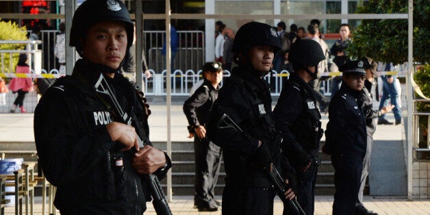 Chinese police stand guard at the scene of an attack at the main train station in Kunming, Yunnan province on March 2, 2014. Knife-wielding assailants left at least 29 people dead and more than 130 wounded in an unprecedented attack at a Chinese train station, with state media blaming separatists from Xinjiang. AFP PHOTO/Mark RALSTON (Photo credit should read MARK RALSTON/AFP/Getty Images)