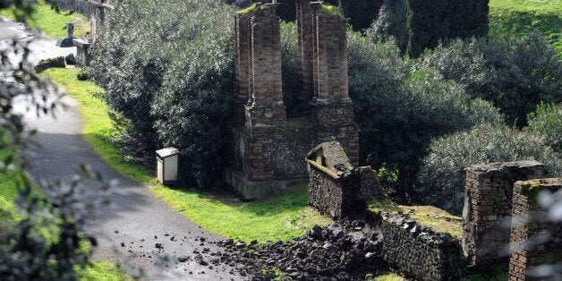 Photo taken on March 2, 2014 shows the damaged wall of a tomb at the ancient ruins of Pompeii, near Naples, southern Italy. The Temple of Venus and the wall of a tomb in the long-neglected ruins of Pompeii near Naples were found damaged on Sunday, possibly due to heavy rain. Custodians found that parts of an archway in the temple had fallen off and a wall in the necropolis, the biggest in the ancient Roman city -- had tumbled and have closed the areas to the public. AFP PHOTO / MARIO LAPORTA (Photo credit should read MARIO LAPORTA/AFP/Getty Images)