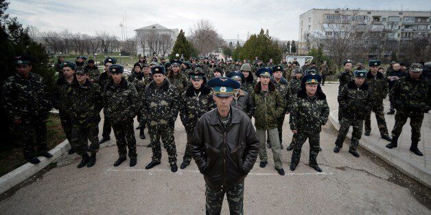Sevastopol Air Base second in command Olieg Podapalov (C) faces with some of his men Ukranian pro-russian protesters demonstrating outside the base in Belbek, not far from Sevastopol on March 6, 2014. Ukraine's premier Arseniy Yatsenyuk on Thursday dubbed as illegitimate a request by the local parliament in Crimea to become part of Russia. AFP PHOTO/Filippo MONTEFORTE (Photo credit should read FILIPPO MONTEFORTE/AFP/Getty Images)
