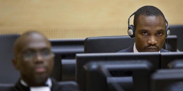 Democratic Republic of Congo militia leader Germain Katanga (C) sits in the courtroom of the the International Criminal Court (ICC) in The Hague prior his trial, 22 October 2007. The ICC prosecutor accuses Katanga, 29, of massacring villagers, using child soldiers and sexually enslaving women in the northeastern Ituri region of the Democratic Republic of Congo. AFP PHOTO / ANP - ROBERT VOS (Photo credit should read ROBERT VOS/AFP/Getty Images)