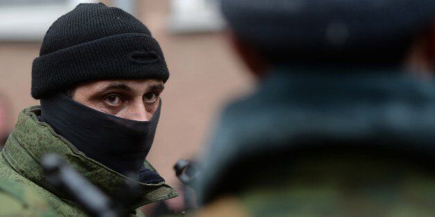 A member of the new Pro-Russian forces dubbed the 'military forces of the autonomous republic of Crimea' looks on before their swearing-in ceremony in the Republican military enlistment complex in Simferopol on March 10, 2014. Ukraine sought urgent Western backing after Russian President Vladimir Putin insisted that Crimea had the right to join his country even while hinting at a readiness for dialogue. The self-declared leadership on the predominantly ethnic Russian peninsula of Crimea has proclaimed independence from Kiev and set a March 16 referendum on switching over to Kremlin rule. AFP PHOTO/Filippo MONTEFORTE (Photo credit should read FILIPPO MONTEFORTE/AFP/Getty Images)