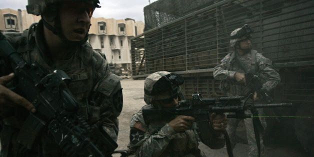 Baghdad, IRAQ: US soldiers from the Bravo Company 5-20 Infantry Regiment engage in a sustained gunfight with unidentified gunmen after their combat outpost came under attack, at the Adamiyah neighborhood of northern Baghdad during day five of Operation Arrowhead Strike VI, 10 February 2007. The regiment combined with the 82nd Airborne division 'surge' troops came under sustained fire for almost an hour responding with riffle and machinegun fire as they clashed with gunmen at one of the first combat outposts set up by US and Iraqi troops in downtown Baghdad as part of the new Baghdad security plan. AFP PHOTO/DAVID FURST (Photo credit should read DAVID FURST/AFP/Getty Images)