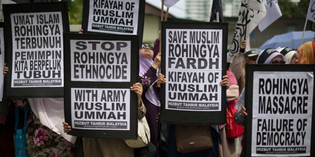 Malaysian Muslim activists display flags and banners during a peaceful protest against the persecution of Rohingya Muslims in Myanmar, outside the Myanmar embassy in Kuala Lumpur on February 14, 2014. Several people including women and a child have been killed in an attack on Rohingya Muslims in strife-torn western Myanmar, a rights group said on January 18, as the S voiced alarm. AFP PHOTO / MOHD RASFAN (Photo credit should read MOHD RASFAN/AFP/Getty Images)