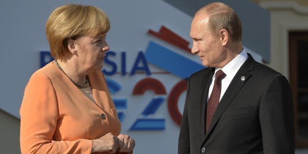 Russias President Vladimir Putin welcomes Germanys Chancellor Angela Merkel at the start of the G20 summit on September 5, 20