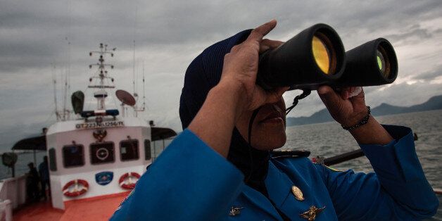 A personnel of Indonesia's National Search and Rescue looks over horizon during a search in the Andaman sea area around northern tip of Indonesia's Sumatra island for the missing Malaysian Airlines flight MH370 on March 17, 2014. The last words spoken from the cockpit of the Malaysian passenger jet that went missing 10 days ago were believed to have been spoken by the co-pilot, the airline's top executive said Monday. AFP PHOTO / CHAIDEER MAHYUDDIN (Photo credit should read CHAIDEER MAHYUDDIN/AFP/Getty Images)