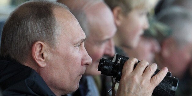 GRODNO, BELARUS - SEPTEMBER 26: Russian President Vladimir Putin (C) and Belarussian President Alexander Lukashenko (R) watch joint Russian-Belarussian military exercises at the polygon on September 26, 2013 in Grodno, Belarus. (Photo by Sasha Mordovets/Getty Images)