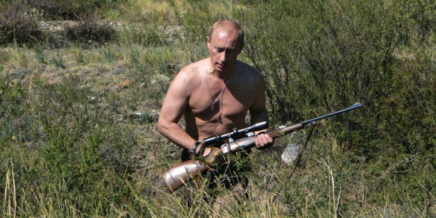 This pool picture provided 03 September 2007 shows Russian President Vladimir Putin carrying a hunting rifle in the Republic