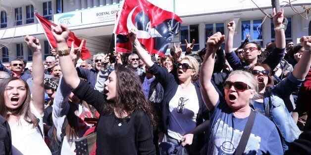 Supporters of Republican People's Party (CHP) shout anti-government slogans and wave flags bearing the portrait of Mustafa Kemal Ataturk, the founder of Modern Turkey, outside the Supreme Electoral Council (YSK) in Ankara April 1, 2014. Turkish police on April 1 deployed water cannon against protesters who alleged vote-rigging in weekend local polls in which the Islamic-rooted party of Premier Recep Tayyip Erdogan claimed sweeping victories. About 2,000 supporters of the main secular opposition party had massed outside the elections authority in the capital Ankara, chanting 'Thief Tayyip!' and 'Ankara, don't sleep. Stand up for your vote!' AFP PHOTO/ADEM ALTAN (Photo credit should read ADEM ALTAN/AFP/Getty Images)