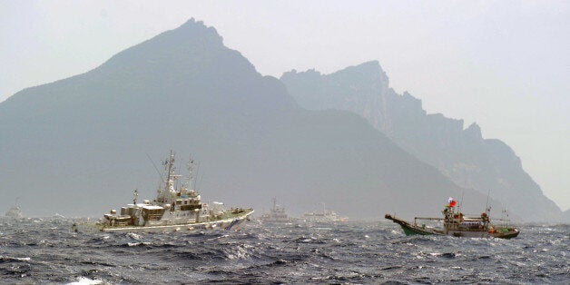 A Taiwan fishing boat (R) is blocked by a Japan Coast Guard (L) vessel near the disputed Diaoyu / Senkaku islands in the East China Sea on September 25, 2012. Coastguard vessels from Japan and Taiwan duelled with water cannon after dozens of Taiwanese boats escorted by patrol ships sailed into waters around Tokyo-controlled islands. Japanese coastguard ships sprayed water at the fishing vessels, footage on national broadcaster NHK showed, with the Taiwanese patrol boats directing their own high-pressure hoses at the Japanese ships. AFP PHOTO / Sam Yeh (Photo credit should read SAM YEH/AFP/GettyImages)