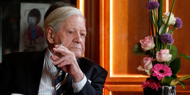 Former German Chancellor Helmut Schmidt smokes a cigarette during a meeting with Prime Minister of China, Li Keqiang (not in