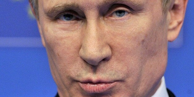 Russian President Vladimir Putin gestures speaks during a press conference with EU Council president and European Commission