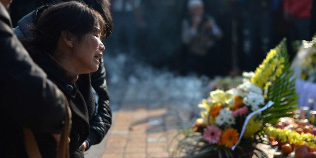 This picture taken on March 7, 2014 shows a woman crying as she mourns at the scene of the terror attack at the main train station in Kunming, southwest China's Yunnan province. Attackers who launched a brutal mass knifing at a Chinese train station acted in desperation after a failed attempt to leave the country and become jihadists overseas, a Chinese official was quoted as saying on March 12. Both Beijing and Washington have described the attack in Kunming which killed 29 people and injured 143 as terrorism. CHINA OUT AFP PHOTO (Photo credit should read STR/AFP/Getty Images)