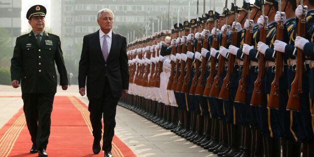 BEIJING, CHINA - APRIL 08: Accompanied by Chinese Minister of Defense Chang Wanquan (L), U.S. Secretary of Defense Chuck Hagel (2nd L) reviews honor guards during a welcome ceremony at the Chinese Defense Ministry headquarters prior to their meeting April 8, 2014 in Beijing, China. Secretary Hagel is on the second stop of an Asian trip, the fourth time since he took office, to Japan, China and Mongolia. (Photo by Alex Wong/Getty Images)