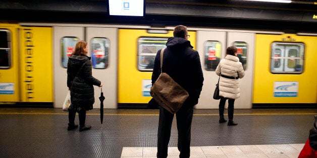 Pedestrians wait to board a subway train at an underground station in Naples, Italy, on Saturday, Feb. 1, 2014. In Naples, the local youth unemployment rate in 2012 was 53.6 percent compared to a national average of 35.3 percent. Photographer: Alessia Pierdomenico/Bloomberg via Getty Images