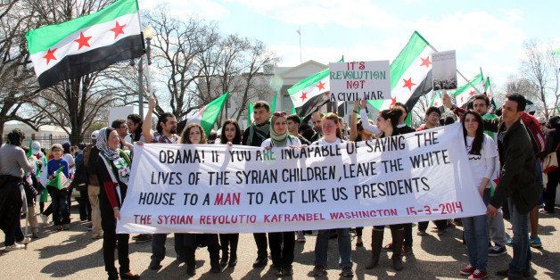WASHINGTON, DC - MARCH 15 : Demonstrators gather in front of the White House during a protest against Assad regime on the third anniversary of the start of the Syrian conflict in Washington, DC, on March 15, 2014. (Photo by Erkan Avci/Anadolu Agency/Getty Images)