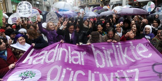 Turkish women hold a banner reading 'Women, we are strong together' during a march at Istiklal avenue in Istanbul, as part of the 'International Women's Day' on March 8, 2014. The 'International Women's Day' dates back to the beginning of the 20th Century and has been observed by the United Nations since 1975. AFP PHOTO / OZAN KOSE (Photo credit should read OZAN KOSE/AFP/Getty Images)