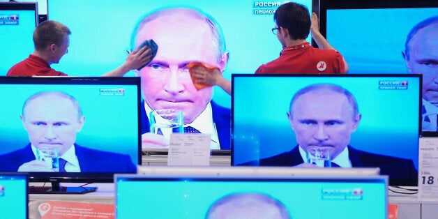 MOSCOW, RUSSIA - APRIL 17: Shop assistants clean a TV screen during Russian President Vladimir Putin's nationally televised question and answer session in a shop on April 17, 2014 in Moscow, Russia. Putin accused today Ukraine's new authorities of driving the country towards the abyss but said that dialogue was the only way out of the intensifying crisis. (Photo Dmitri Dukhanin/Kommersant via Getty Images)