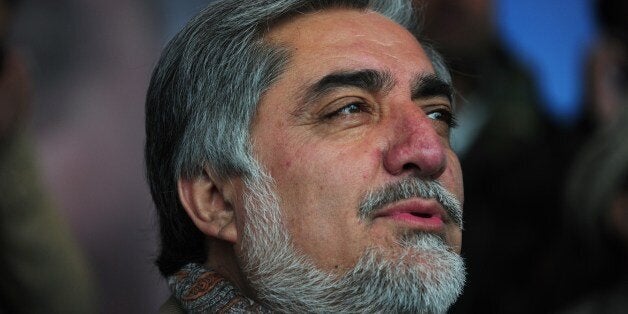 Afghan presidential candidate Abudullah Abdullah listens as he is introduced during an election rally on the last day of camp