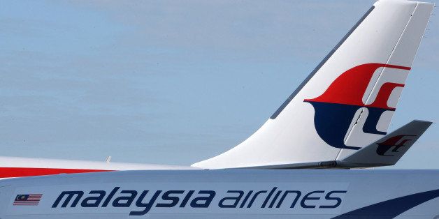 The Malaysian Airline System Bhd. (MAS) logo is displayed on the company's aircraft at Kuala Lumpur International Airport (KLIA) in Sepang, Malaysia, on Thursday, Jan. 31, 2013. Malaysia Airlines joins the Oneworld airline alliance tomorrow. Photographer: Goh Seng Chong/Bloomberg via Getty Images