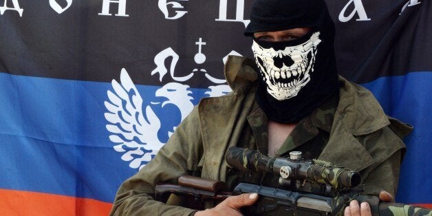 An armed pro-Russian fighter poses at a checkpoint near the eastern Ukranian city of Slavyansk on May 10, 2014. Tensions were running at fever pitch in eastern Ukraine Saturday on the eve of an independence referendum, as rebels briefly held several Red Cross staff on suspicion of espionage. AFP PHOTO / VASILY MAXIMOV (Photo credit should read VASILY MAXIMOV/AFP/Getty Images)