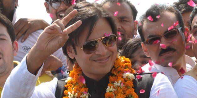 Indian Bollywood actor Vivek Oberoi (C) gestures to supporters during an election campaign event for unseen Bharatiya Janata Party (BJP) candidate for Amritsar's parliamentary seat Arun Jaitley in Amritsar on April 17, 2014. India is hosting its biggest day of voting in its marathon election, with the Nehru-Gandhi dynasty battling to save the ruling Congress party from defeat to opposition Hindu nationalist leader Narendra Modi. Voters lined up at 7:00 am (0130 GMT) in 121 constituencies across a dozen states where more than 195 million voters are eligible to cast ballots in the largest single day of polling in the five-week election which ends May 12.AFP PHOTO/NARINDER NANU (Photo credit should read NARINDER NANU/AFP/Getty Images)