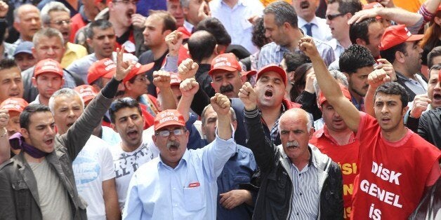 People chant slogans as they take part in a protest against the government of the Turkish Prime Minister, in Ankara, on May 15, 2014, three days after an explosion and fire at a coal mine in Soma in western Turkey which killed hundreds of workers. Anger at Turkey's government boiled over today as tens of thousands went on strike and police clashed with protesters after at least 282 workers died in one of the worst mining accidents in modern history. AFP PHOTO / ADEM ALTAN (Photo credit should read ADEM ALTAN/AFP/Getty Images)