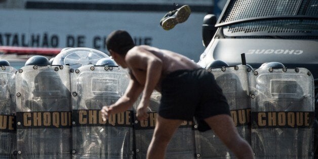 The Special Riot Police unit (CHOQUE) carries out a drill for controlling civil disorders, at their headquarters in Rio de Janeiro, Brazil, on May 15, 2014. CHOQUE has received deployment advice from the US Federal Bureau of Investigation (FBI) in partnership with the Department of the Los Angeles Police Department and the Chicago Police less than a month before the start of the FIFA World Cup Brazil 2014. AFP PHOTO / YASUYOSHI CHIBA (Photo credit should read YASUYOSHI CHIBA/AFP/Getty Images)