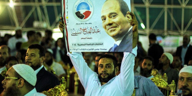 CAIRO, EGYPT - MAY 20: An Egyptian holds poster of president candidate Abdel Fattah el-Sisi during Younis Makhyoun (not seen) head of Egypt's Salafist Nour Party speaks about the Egypt's presidential election which will be held on May 26-27 in Cairo, Egypt on May 20, 2014. Makhyoun will support president candidate and former Defence Minister Abdel Fattah el-Sisi in the Egypt's presidential election. (Photo by Ibrahim Ramadan/Anadolu Agency/Getty Images)