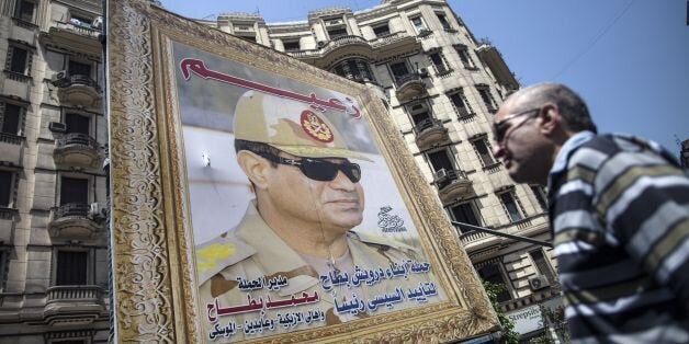 A poster of Egyptian ex-army chief and leading presidential candidate Abdel Fattah al-Sisi stand near a building in central C