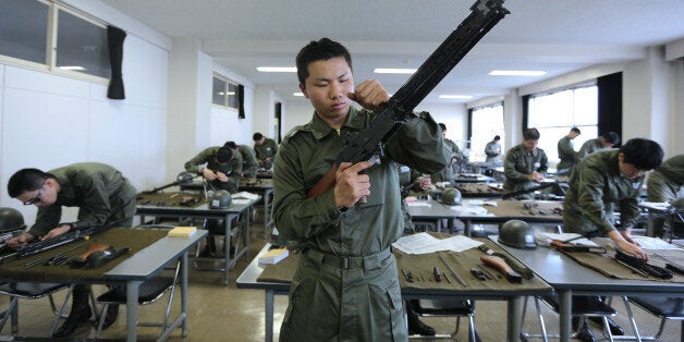 National Defense Academy of Japan (NDA) cadets dismantle and reassemble rifles during a class at the NDA campus in Yokosuka,