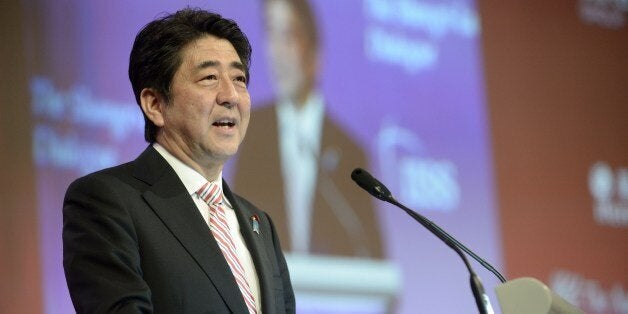 Prime Minister Shinzo Abe delivers his speech at the 13th International Institute for Strategic Studies (IISS) Shangri-La Dialogue (SLD) on May 30, 2014 in Singapore. AFP PHOTO / ROSLAN RAHMAN (Photo credit should read ROSLAN RAHMAN/AFP/Getty Images)