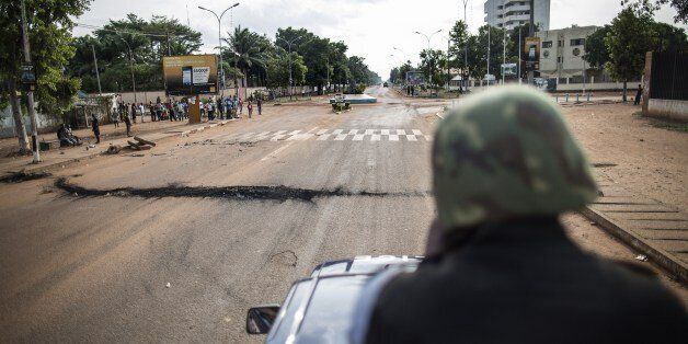 A member of the Central African republic National Gendarmerie patrols on his truck in an avenue at the Lakengua district of Bangui on May 29, 2014. At least 10 people were killed and several others wounded in clashes on May 28, 2014 in the capital of the strife-torn Central African Republic. The violence erupted during the afternoon close to the Notre-Dame de Fatima church in Bangui, according to a police officer and a military source. AFP PHOTO/MARCO LONGARI (Photo credit should read MARCO LONGARI/AFP/Getty Images)