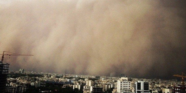 A picture taken with a smart-phone shows a sandstorm engulfing the Iranian capital Tehran on June 02, 2014. A massive sandstorm and record winds killed at least four people in Tehran, plunging the city into darkness, knocking out power supplies, damaging buildings and causing massive disruption. AFP PHOTO/STR (Photo credit should read STR/AFP/Getty Images)