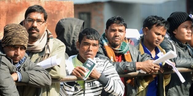 Nepalese migrant workers queue to receive official documents in order to leave Nepal from the Labour department in Kathmandu on January 27, 2014. Nearly 200 Nepali migrant workers died in Qatar in 2013, many of them from heart failure, officials said, figures that highlight the grim plight of labourers in the Gulf nation. AFP PHOTO/Prakash MATHEMA (Photo credit should read PRAKASH MATHEMA/AFP/Getty Images)