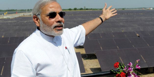 Chief Minister of the western Indian state of Gujarat Narendra Modi gestures as he poses at the inauguration of a solar farm in the village of Gunthawada, Banaskantha district, some 175kms. from Ahmedabad on October 14, 2011. Modi inaugrated the 30MW solar farm - said to be Asia's largest - which has been set up by Moser Baer Clean Energy. AFP PHOTO/Sam PANTHAKY (Photo credit should read SAM PANTHAKY/AFP/Getty Images)