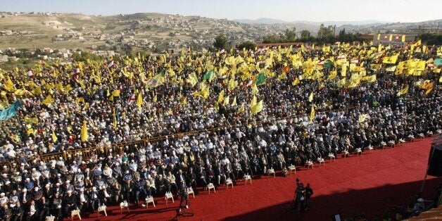 Lebanese supporters of Shiite Hezbollah movement gather in the southern town of Bint Jbeil, to watch a televised address by Hassan Nasrallah, the movement's chief, to mark the 14th anniversary of the Israeli withdrawal from south Lebanon. Nasrallah said that the Syrian regime and the 'resistance axis' including his Lebanese Shiite militant movement would triumph in Syria's conflict. AFP PHOTO/MAHMOUD ZAYYAT (Photo credit should read MAHMOUD ZAYYAT/AFP/Getty Images)