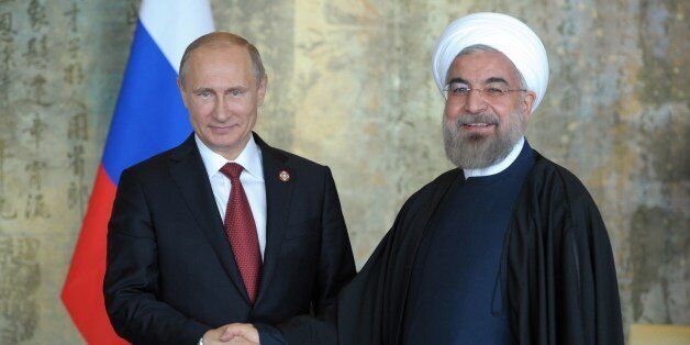Russia's President Vladimir Putin (L) shakes with his Iran's counterpart Hassan Rouhani during their bilateral meeting on the sidelines of the fourth Conference on Interaction and Confidence Building Measures in Asia (CICA) summit in Shanghai on May 21, 2014. China is hosting the CICA summit in Shanghai with Chinese President Xi Jinping and Russian leader Vladimir Putin among the heads of state attending. AFP PHOTO / RIA-NOVOSTI / POOL / ALEXEY DRUZHININ (Photo credit should read ALEXEY DRUZHININ/AFP/Getty Images)