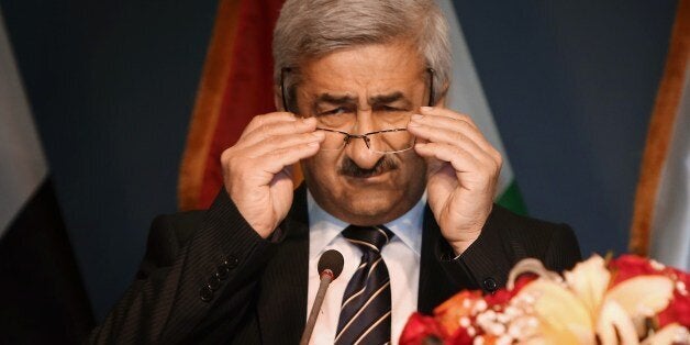 Sarbast Mustafa (C), Chairman of the Independent High Electoral Commission, adjusts his glasses as he speaks to the press to