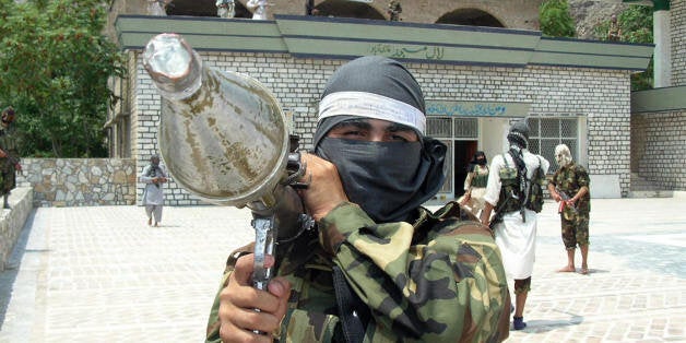 A Pakistani pro-Taliban militant carries rocket propelled granade launcher (RPG) as he stands inside the shrine in Lakaro village in the lawless Mohmand tribal district bordering Afghanistan, some 60 kilometers (37 miles) northwest of Peshawar, 30 July 2007. Pro-Taliban militants who seized a historic shrine and named it after Islamabad's radical Red Mosque said 30 July they would resist with suicide bombing if Pakistani troops tried to flash them out. AFP PHOTO/S H KHAN (Photo credit should read STRDEL/AFP/Getty Images)