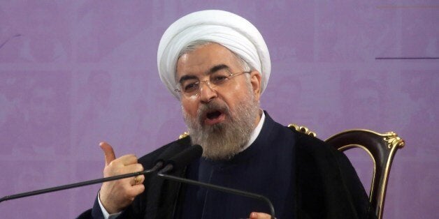 Iranian President Hassan Rouhani speaks during a press conference in the capital Tehran on June 14, 2014. Iran may consider cooperating with the United States in fighting Sunni extremist fighters in Iraq if Washington acts against them, Rouhani told journalists. AFP PHOTO/ATTA KENARE (Photo credit should read ATTA KENARE/AFP/Getty Images)