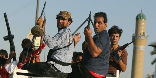 Iraqi men carry their weapons as they volunteer to fight along side the Iraqi security forces against Jihadist militants who have taken over several northern Iraqi cities, on June 15 2014, in the capital Baghdad. Faced with a militant offensive sweeping south toward Baghdad, Prime Minister Nuri al-Maliki announced the Iraqi government would arm and equip civilians who volunteer to fight, and thousands have signed up. AFP PHOTO/AHMAD AL-RUBAYE (Photo credit should read AHMAD AL-RUBAYE/AFP/Getty Images)