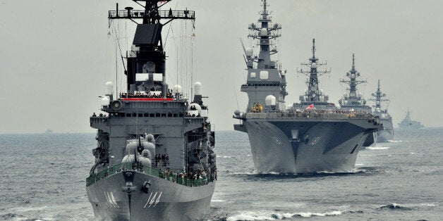 Japan Maritime Self-Defence Force escort ship Kurama (L) sails during their 2012 navy fleet review off Sagami Bay, Japan's Kanagawa prefecture on October 14, 2012. AFP PHOTO / KAZUHIRO NOGI (Photo credit should read KAZUHIRO NOGI/AFP/GettyImages)