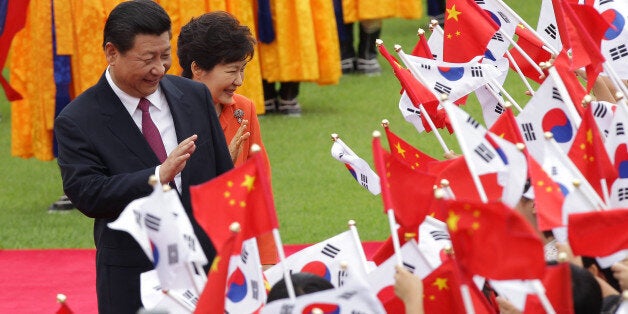 SEOUL, SOUTH KOREA - JULY 03: Chinese President Xi Jinping and South Korean President Park Geun-Hye greet South Korean child