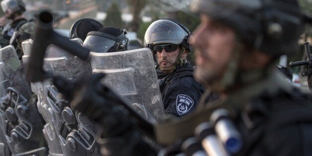 Israeli riot police secure a street during clashes with Palestinian protesters (unseen) in the Arab Israeli city of Ar'Ara, north of Israel, on July 5, 2014. A Palestinian teenager whose abduction and murder caused violent protests was burned alive, autopsy reports show, as clashes over the killing spread Saturday from east Jerusalem to Arab Israeli towns. AFP PHOTO / JACK GUEZ (Photo credit should read JACK GUEZ/AFP/Getty Images)